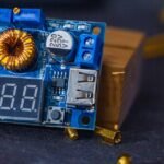 detailed view of a 12V solar charge controller circuit board with digital display, USB port, and electronic components, illustrating the article's focus on circ