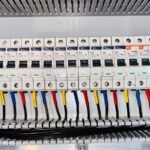 Battery isolator kit wiring and circuit breakers in an electrical panel, illustrating setup options for off-grid power systems