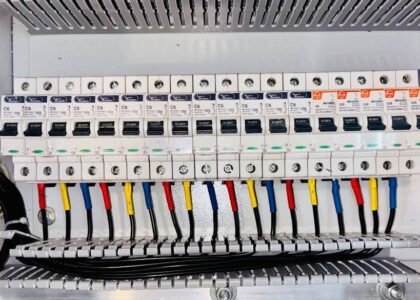 Battery isolator kit wiring and circuit breakers in an electrical panel, illustrating setup options for off-grid power systems