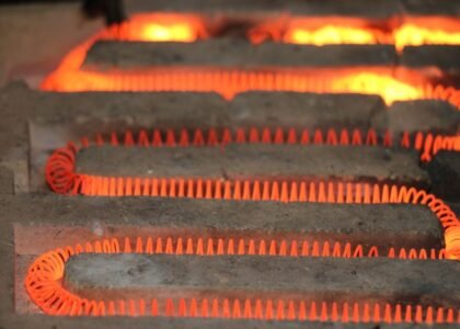 Glowing electric heating coil element, illustrating how lithium battery heaters work to maintain safe battery temperatures.