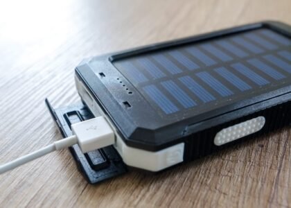 solar powered phone charger charging a device via USB cable, illustrating portable solar charging for phones