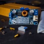 Close-up of a DC to DC charger circuit board with digital display and components, illustrating RV charger selection.