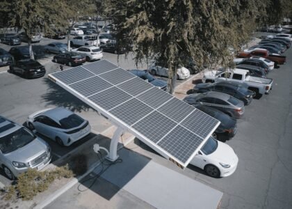 solar-powered carport charging an electric vehicle in a parking lot, illustrating solar charge controller use for lithium batteries