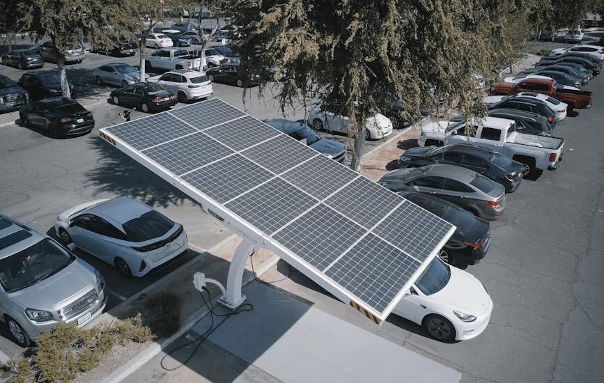 solar-powered carport charging an electric vehicle in a parking lot, illustrating solar charge controller use for lithium batteries
