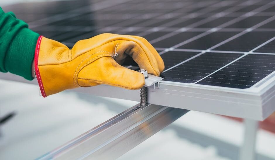 Gloved hand adjusting a solar panel tilt mount bracket, illustrating RV solar panel mounting options for optimal angle.