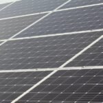 Rows of solar panels installed at a tilt, illustrating how panel angle affects sunlight capture for off-grid power setups.