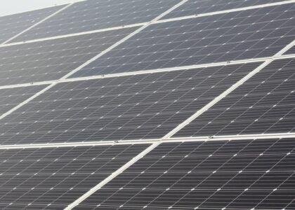 Rows of solar panels installed at a tilt, illustrating how panel angle affects sunlight capture for off-grid power setups.