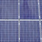 Close-up view of several blue solar panels, illustrating a key component of off-grid power systems for troubleshooting guides.