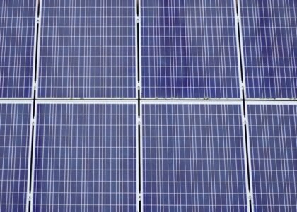 Close-up view of several blue solar panels, illustrating a key component of off-grid power systems for troubleshooting guides.