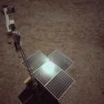 A ground-mounted solar panel array in a dry, open area, illustrating solar generator options for off-grid power needs.