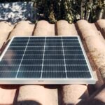 A solar panel installed on a rooftop, relevant to string vs hybrid inverter discussion.