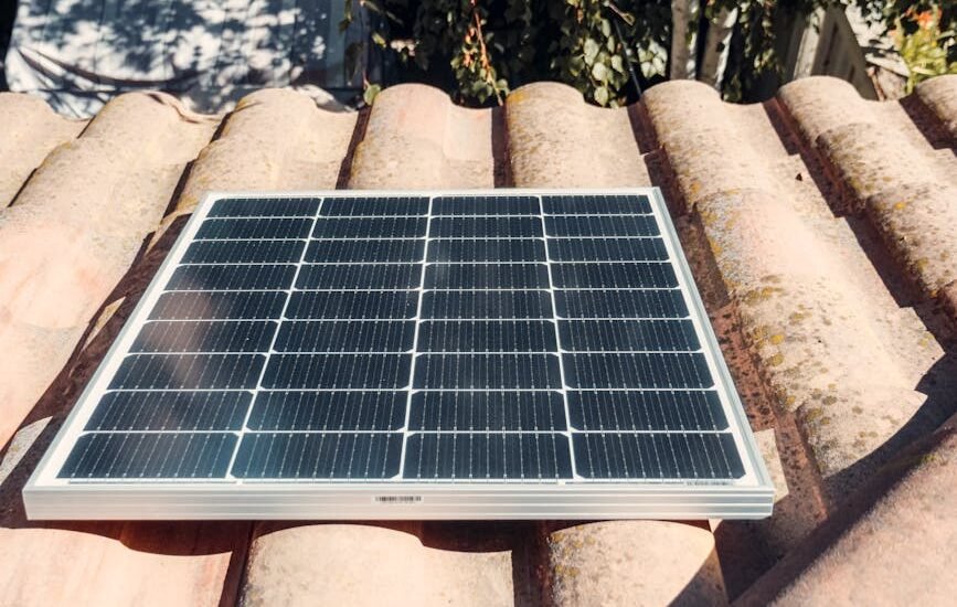 A solar panel installed on a rooftop, relevant to string vs hybrid inverter discussion.