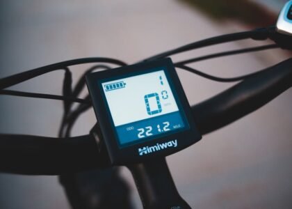 Close-up of a Himiway digital battery monitor on handlebars, illustrating battery monitoring for off-grid power setups