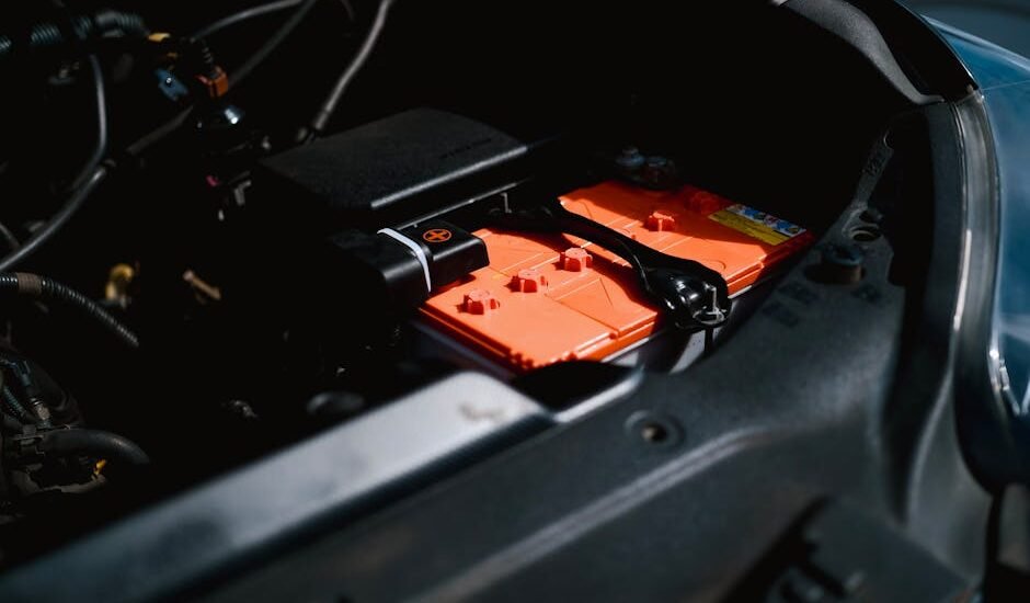 Lithium battery with orange casing installed in an RV engine compartment, illustrating RV lithium battery setup for the best battery review article.