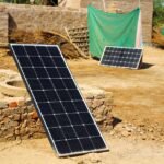 Two different solar panel systems set up outdoors on bare ground, illustrating choices for off-grid power solutions.