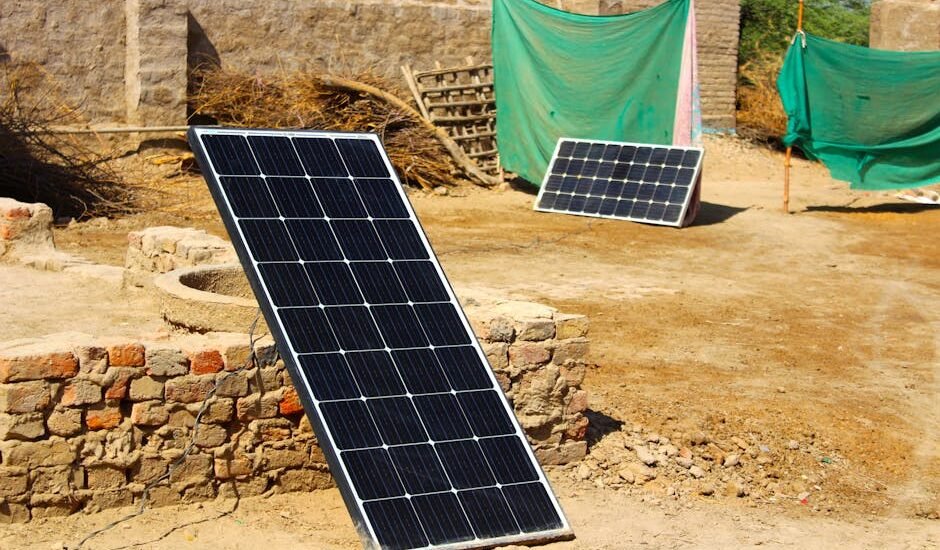 Two different solar panel systems set up outdoors on bare ground, illustrating choices for off-grid power solutions.