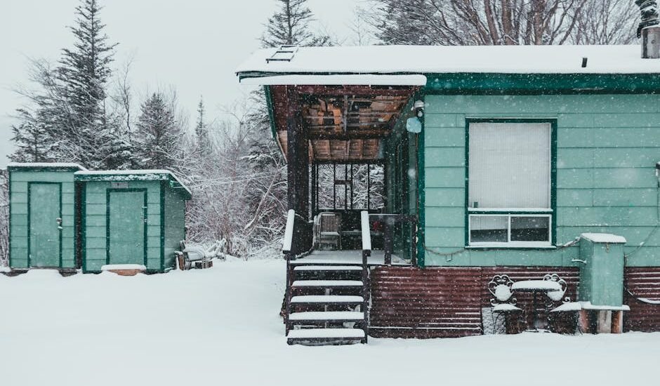 A snowy scene featuring a green cabin and storage sheds, relevant to dual fuel generators.