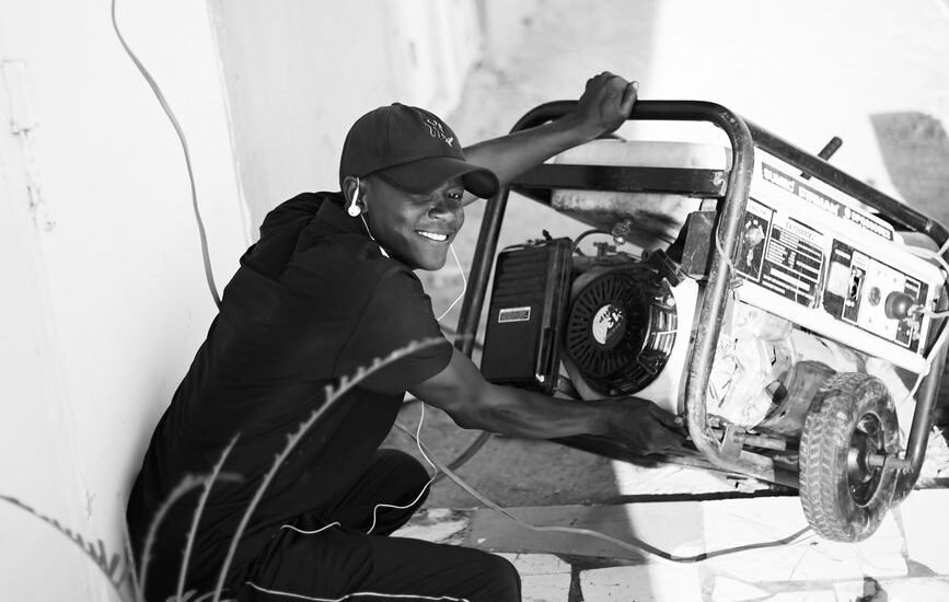 A person lifting a propane generator, illustrating practical use of propane generators.