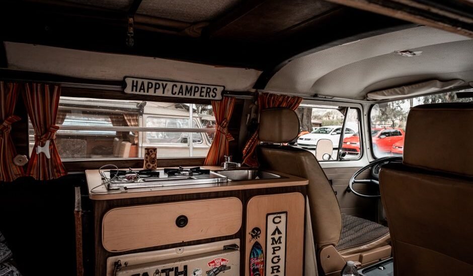 Interior of a camper van showing a portable heater and cooking area, relevant to 12V portable heaters.