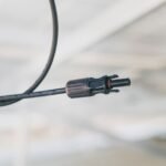 A close-up view of a solar panel cable connector, relevant to choosing the right connectors.