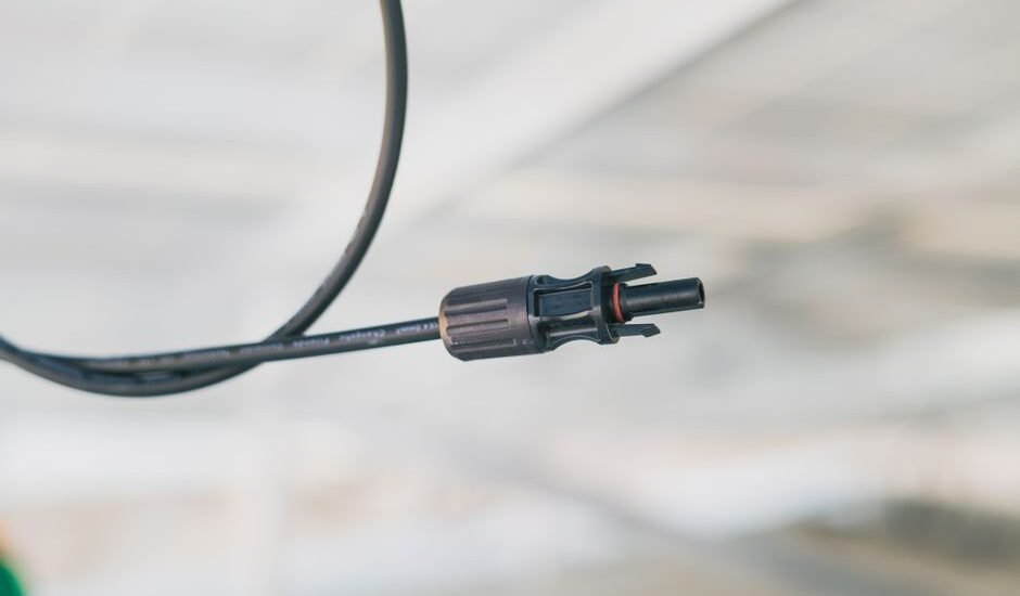 A close-up view of a solar panel cable connector, relevant to choosing the right connectors.
