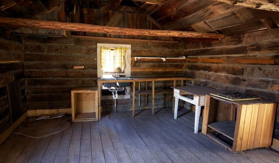 Interior view of a rustic cabin, highlighting the need for solar powered fans.