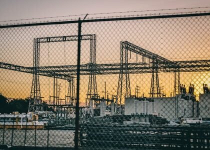 Image showing a generator setup with air-cooled and liquid-cooled systems against a sunset backdrop.