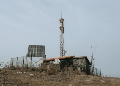 Image showing solar panels and a communication tower, relevant to high and low frequency inverters.