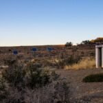 Solar panels in a desert landscape, illustrating the use of charge controllers in off-grid systems.