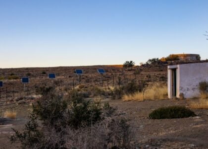Solar panels in a desert landscape, illustrating the use of charge controllers in off-grid systems.