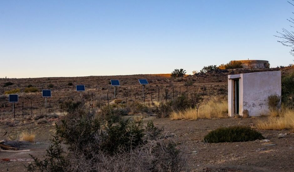Solar panels in a desert landscape, illustrating the use of charge controllers in off-grid systems.