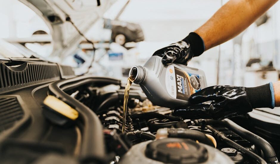 A person pours oil into a generator's engine, illustrating oil change frequency.
