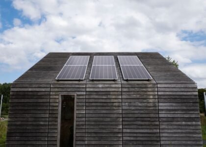 Image showing solar panels on a wooden cabin, relevant to portable vs standby generators.
