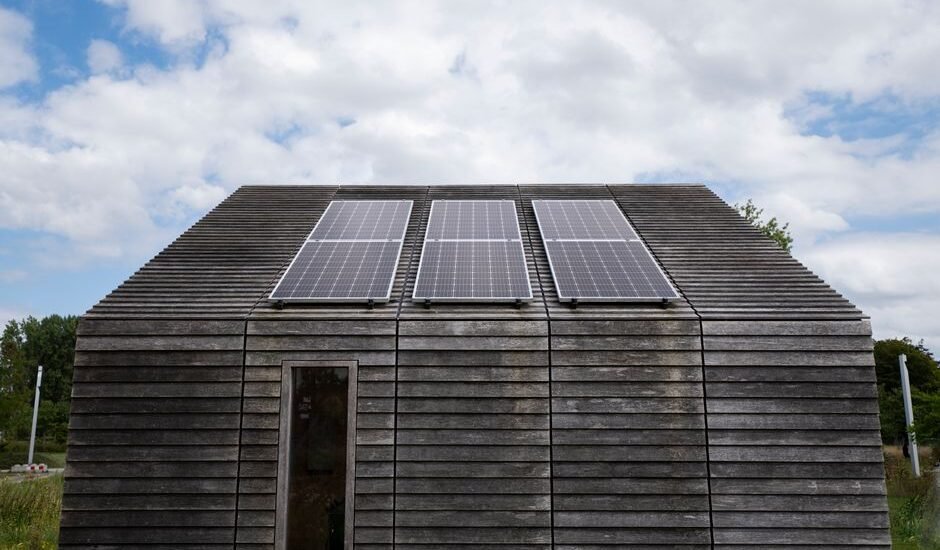 Image showing solar panels on a wooden cabin, relevant to portable vs standby generators.