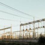A large electric power station with towers and wires, illustrating energy generation.