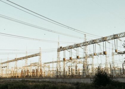 A large electric power station with towers and wires, illustrating energy generation.