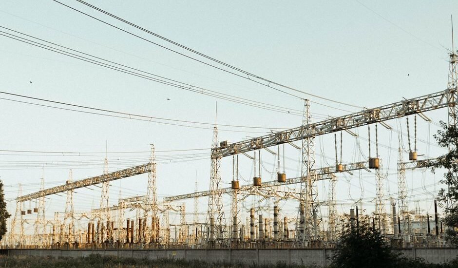 A large electric power station with towers and wires, illustrating energy generation.