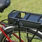 An electric bicycle battery pack mounted on a bike rack, relevant to battery state of charge methods.