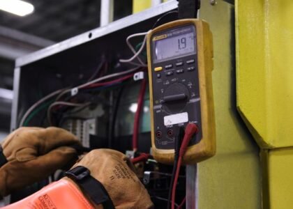 A person testing generator output voltage using a multimeter, illustrating the process described in the article.
