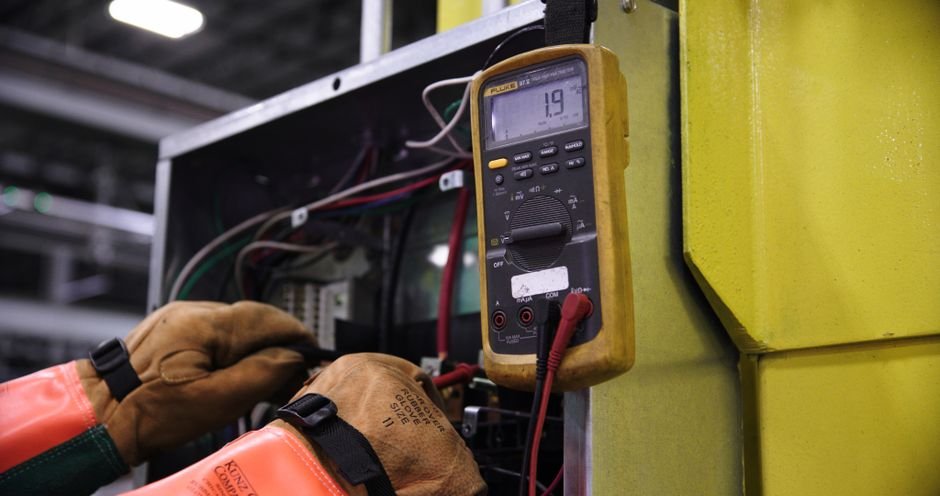 A person testing generator output voltage using a multimeter, illustrating the process described in the article.