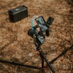 A camera on a tripod with a power source, relevant to lead crystal vs lithium-ion battery discussion.