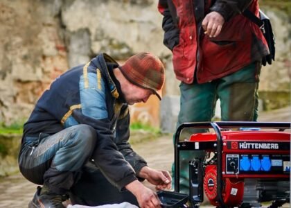 A man examines a generator, illustrating the concept of generator harmonic distortion.